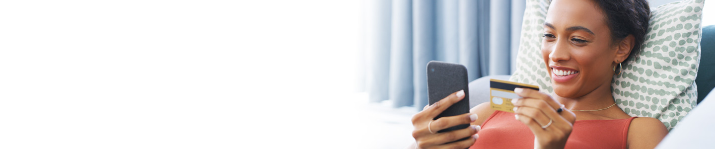 woman holding credit card and mobile phone