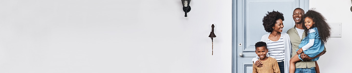 happy family standing outside of house