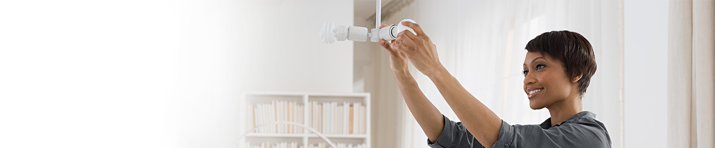 woman screwing in a lightbulb