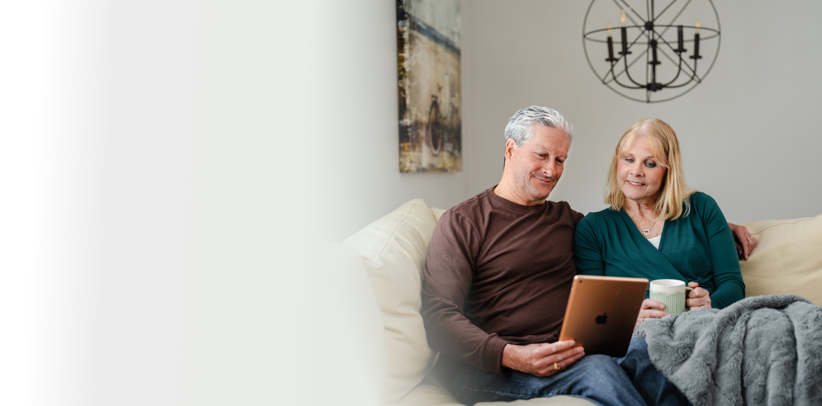 Couple looking at tablet and smiling