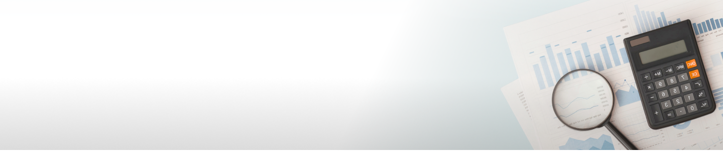 Charts, magnifying glass and calculator on table.